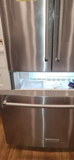 Stainless steel French door refrigerator with ice dispenser and dual compartments