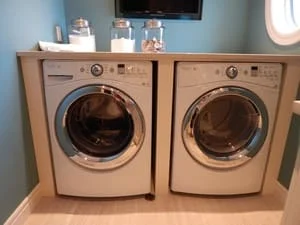 Two front-load washer and dryer units installed side-by-side in utility room