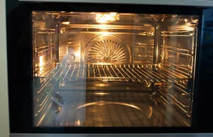 Clean oven interior with visible racks and heating elements after professional cleaning