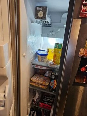 Clean refrigerator interior with organized shelves, containers, and food storage items